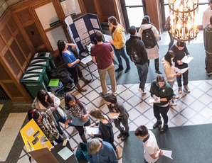crowd of people at a research poster fair